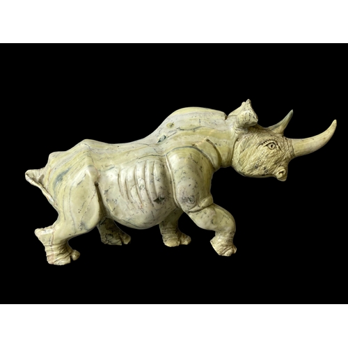 113B - A large pair of Zimbabwean (Shona) Butterjade Rhino carved stone sculptures. 
15 x 30cm