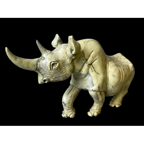 113B - A large pair of Zimbabwean (Shona) Butterjade Rhino carved stone sculptures. 
15 x 30cm