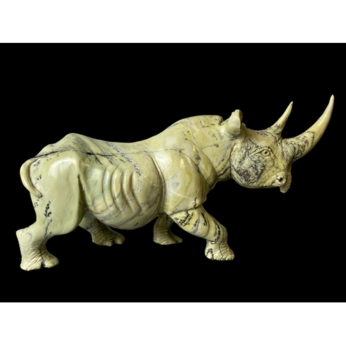 113B - A large pair of Zimbabwean (Shona) Butterjade Rhino carved stone sculptures. 
15 x 30cm