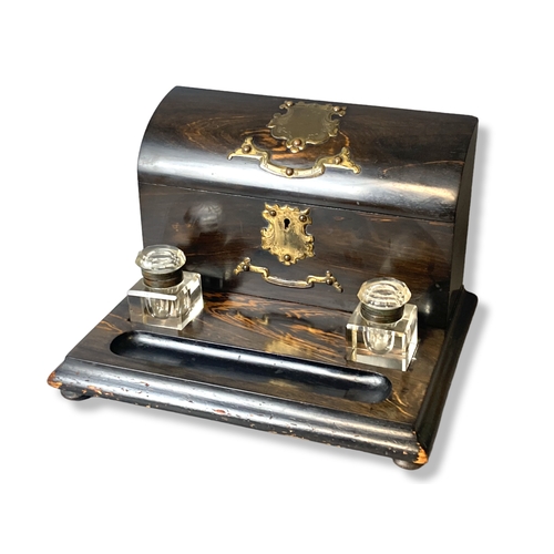 93 - Victorian Coromandel Desk stand with Inkwells and lidded letter box. With brass mounts.
30 x 24 cm