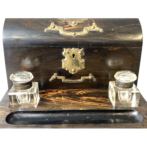 93 - Victorian Coromandel Desk stand with Inkwells and lidded letter box. With brass mounts.
30 x 24 cm