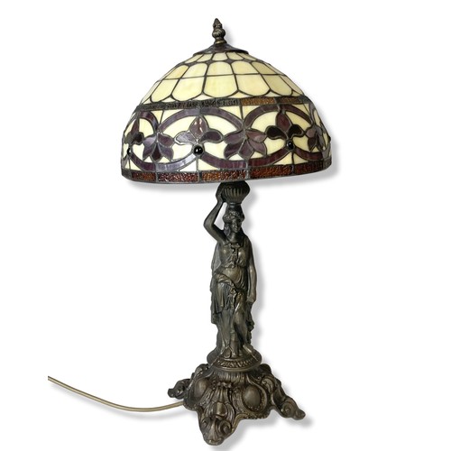 108 - A bronzed metal Tiffany style table lamp. Base in classical lady form. 
55cm tall