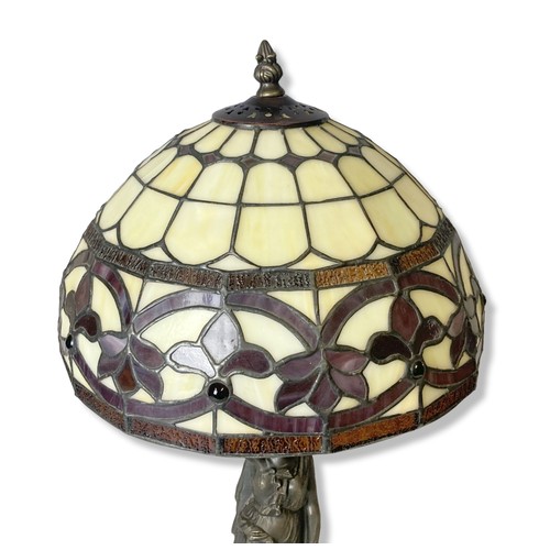 108 - A bronzed metal Tiffany style table lamp. Base in classical lady form. 
55cm tall