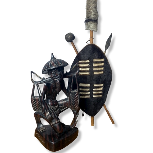 112 - A job lot of Tribal Art, including a Zulu shield set, large Olive wood bowl and metal Giraffe.
