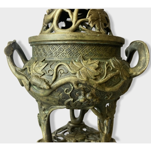 168 - A Chinese Bronze tripod censer with stand & cover.
Relief decorated with Grape vines and rats. 
Four... 