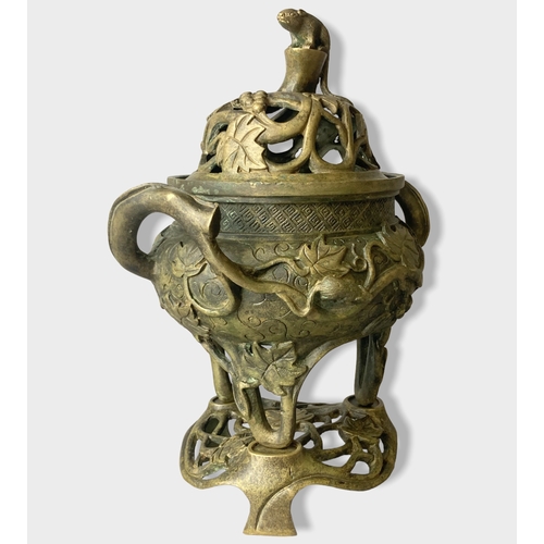 168 - A Chinese Bronze tripod censer with stand & cover.
Relief decorated with Grape vines and rats. 
Four... 