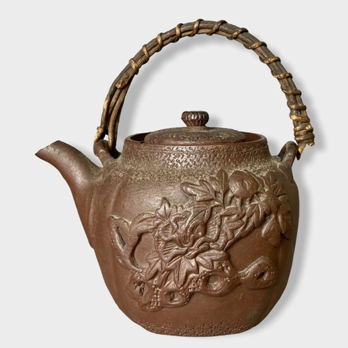 150 - A collection of Chinese teapots. Includes a Yixing relief moulded example, engraved Brass and Cast I... 