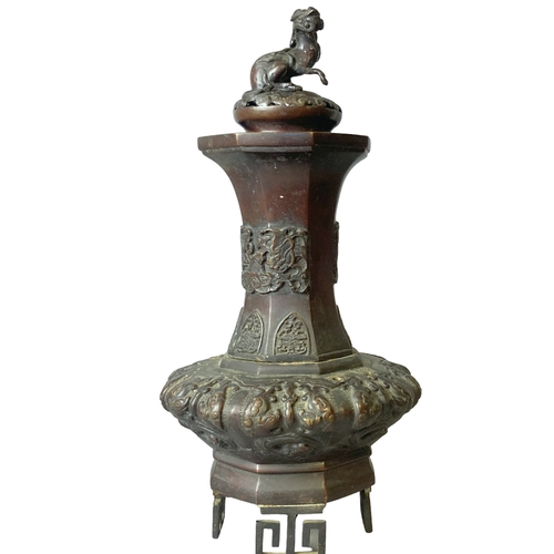 207 - A 19th-century Japanese Bronze vase. Raised on greek-key feet, with relief decorated Dragons & Phoen... 