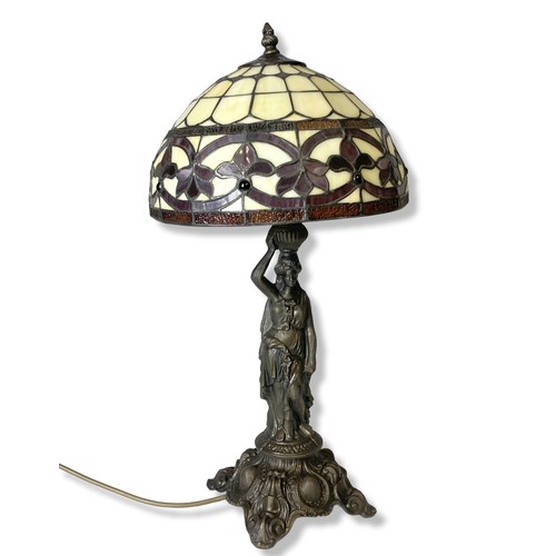 197 - A bronzed metal Tiffany style table lamp. Base in classical lady form. 
55cm tall