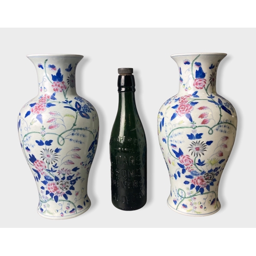 58 - A pair of Chinese hand painted porcelain vases.
Painted with stylised blossoming floral motif. 
Unma... 