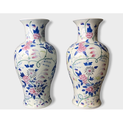 58 - A pair of Chinese hand painted porcelain vases.
Painted with stylised blossoming floral motif. 
Unma... 