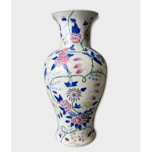 58 - A pair of Chinese hand painted porcelain vases.
Painted with stylised blossoming floral motif. 
Unma... 