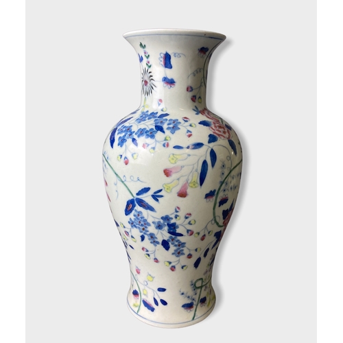 58 - A pair of Chinese hand painted porcelain vases.
Painted with stylised blossoming floral motif. 
Unma... 