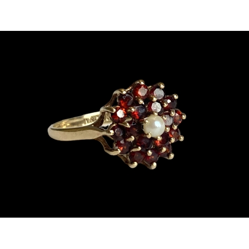 26 - vintage 9 carat gold Garnet & pearl ladies ring. Set with central seed pearl supported by cluster of... 