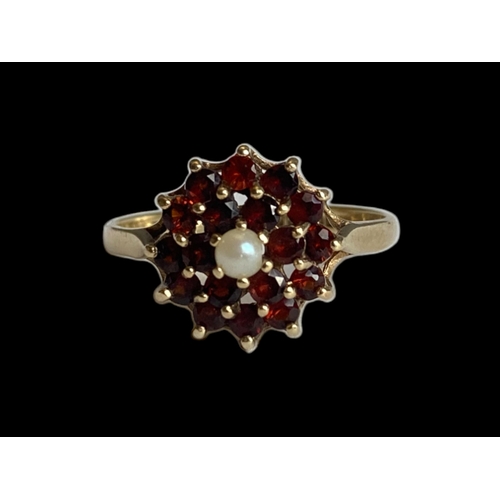 26 - vintage 9 carat gold Garnet & pearl ladies ring. Set with central seed pearl supported by cluster of... 