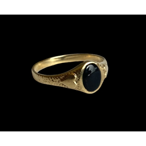 36 - A 9 carat gold & Whitby Jet ladies ring.
Decorated with Hearts to shoulder and set with an Oval Jet.... 