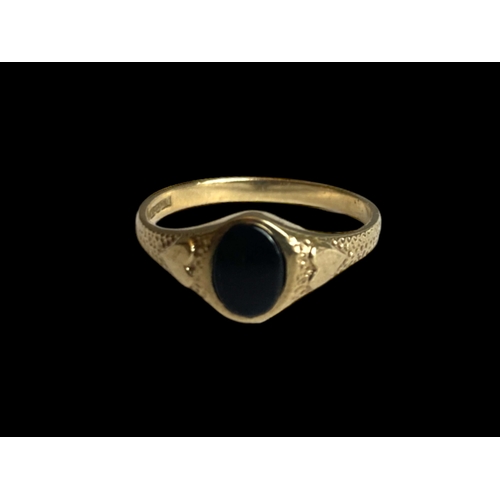 36 - A 9 carat gold & Whitby Jet ladies ring.
Decorated with Hearts to shoulder and set with an Oval Jet.... 