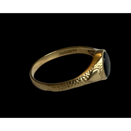 36 - A 9 carat gold & Whitby Jet ladies ring.
Decorated with Hearts to shoulder and set with an Oval Jet.... 