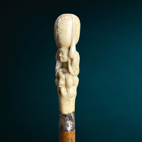 178 - A Japanese Meiji period carved walking stick.
Carved Marine bone figural handle, signed. 
With silve... 