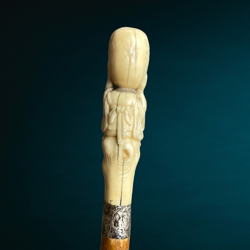 178 - A Japanese Meiji period carved walking stick.
Carved Marine bone figural handle, signed. 
With silve... 