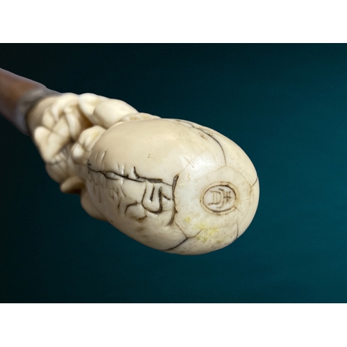 178 - A Japanese Meiji period carved walking stick.
Carved Marine bone figural handle, signed. 
With silve... 