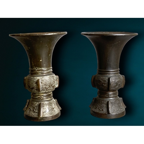 179 - A near pair of Chinese Archaistic Bronze Gu vases. 
Both decorated with Taotie and other zoomorphic ... 