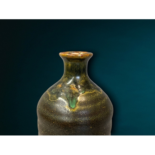 140 - A Japanese Shino Chawan 'Wabi Sabi' pottery Sake bottle.
Signed to base.
19cm tall.