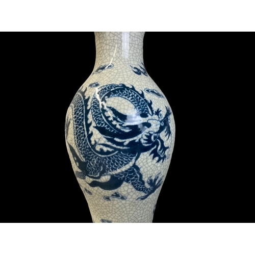 169 - A CHINESE CRACKLE GLAZED PORCELAIN BALUSTER VASE. HAND PAINTED WITH A 5-CLAW DRAGON AMONGST THE CLOU... 