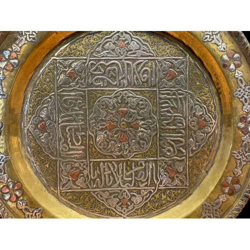 68 - A 19TH CENTURY INDIAN BRASS, SILVER & COPPER APPLIQUE PLATE.
21CM DIAMETER