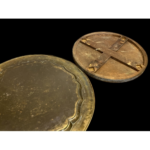 70 - TWO LARGE VINTAGE PERSIAN BRASS TABLE TRAYS. 
LARGEST MEASURES - 59CM DIAMETER