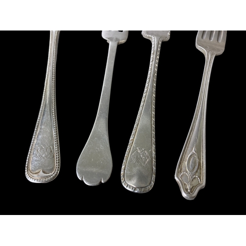 60 - A collection of Silver flatwares. Includes four silver forks, a spoon, knife and two teaspoons. All ... 