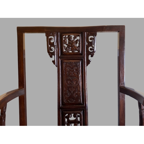 206 - A CHINESE CARVED HARDWOOD ARMCHAIR, 20TH CENTURY. The splat carved with a figure and pierced apron. ... 