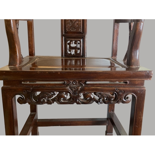 206 - A CHINESE CARVED HARDWOOD ARMCHAIR, 20TH CENTURY. The splat carved with a figure and pierced apron. ... 