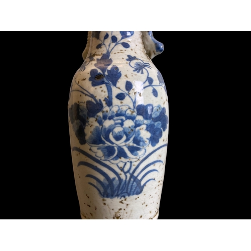 210 - A Chinese Qing dynasty blue & white porcelain vase. Hand painted with a blossoming Peony amongst out... 