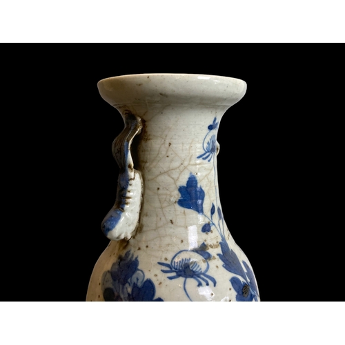 210 - A Chinese Qing dynasty blue & white porcelain vase. Hand painted with a blossoming Peony amongst out... 