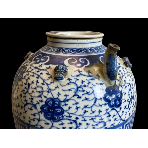 213 - A large Chinese Qing dynasty porcelain Wine / Water pot. 
Hand painted with scrolling stylised bloss... 