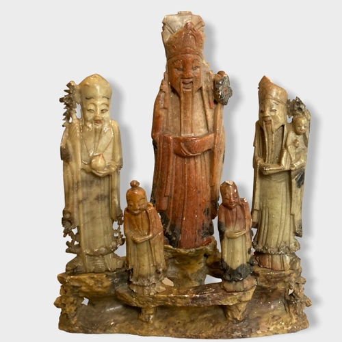 224 - A collection of Chinese carved soapstone figures. Includes a five person figure group, A carved Ram ... 