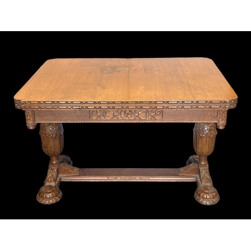 19 - A VICTORIAN CARVED OAK EXTENDING DINING TABLE.