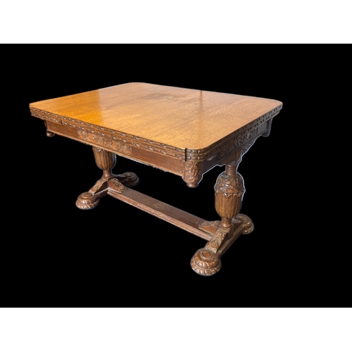 19 - A VICTORIAN CARVED OAK EXTENDING DINING TABLE.