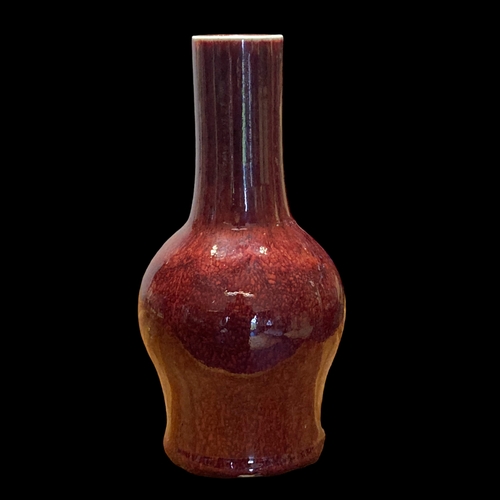 158A - A QING DYNASTY CHINESE SANG DE BOEUF FLAMBE GLAZE BOTTLE VASE.
33CM TALL.