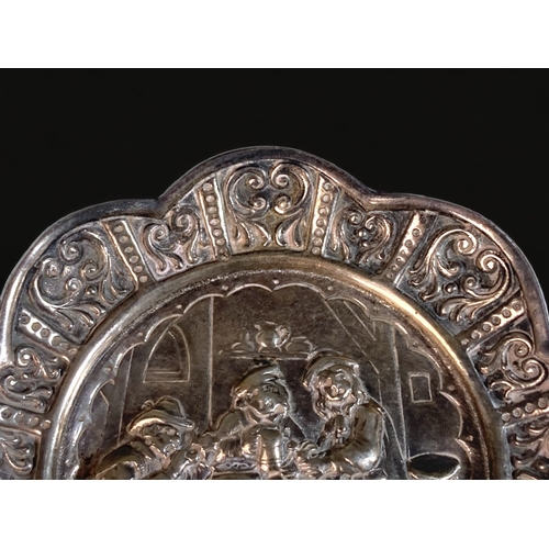 27 - A DUTCH SILVER REPOUSSE DECORATED PIN TRAY.
DEPICTING A PUB SCENE WITH STYLISED BORDER PATTERN. 
12C... 