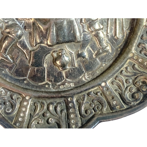 27 - A DUTCH SILVER REPOUSSE DECORATED PIN TRAY.
DEPICTING A PUB SCENE WITH STYLISED BORDER PATTERN. 
12C... 