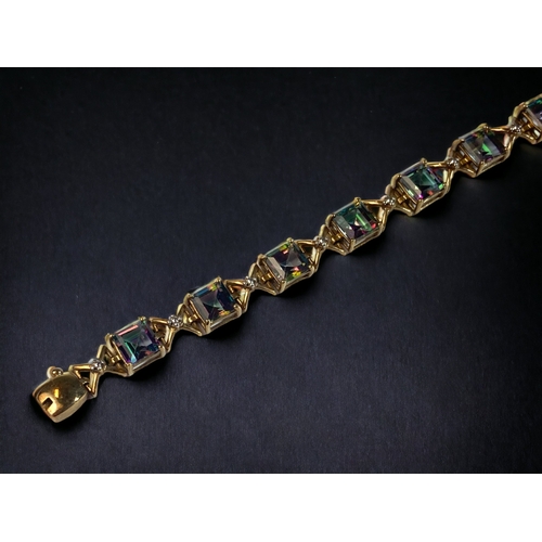 48 - A LADIES 9CT GOLD & MYSTIC TOPAZ LINE BRACELET. 
21CM LONG