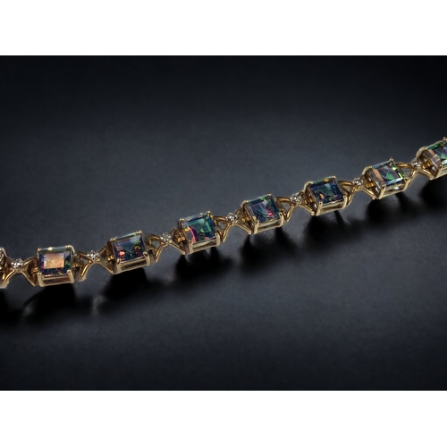 48 - A LADIES 9CT GOLD & MYSTIC TOPAZ LINE BRACELET. 
21CM LONG