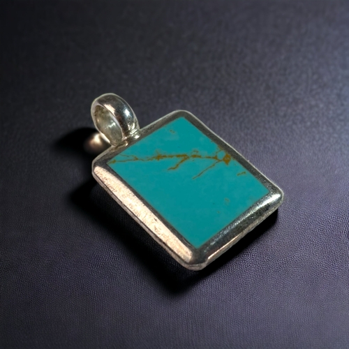 51 - A 925 SILVER & POLISHED TURQUOISE PENDANT.  
40 X 22MM