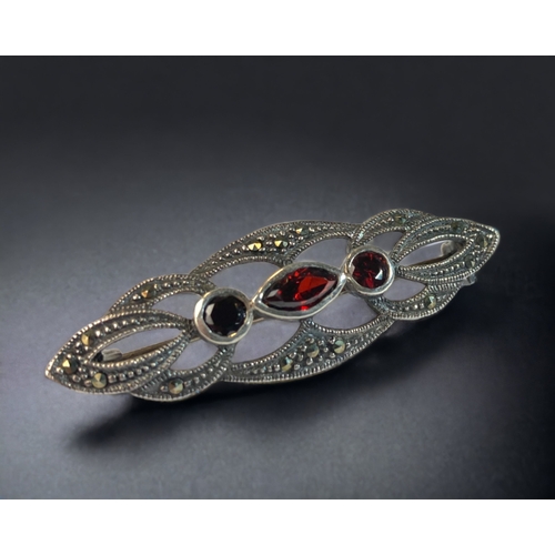 81 - A 925 SILVER LADIES RUBY AND MARCASITE BROOCH. 
45MM