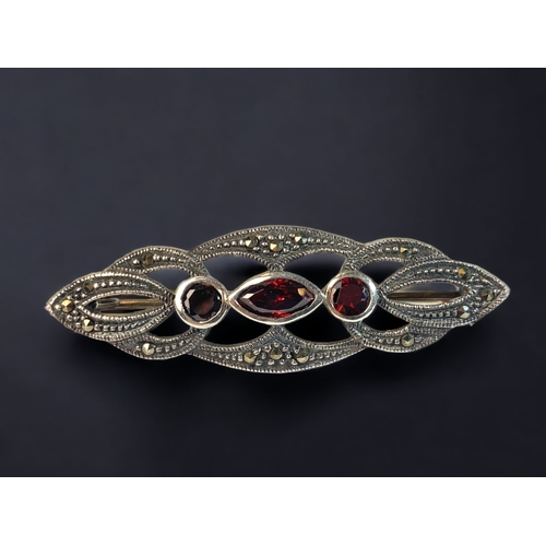 81 - A 925 SILVER LADIES RUBY AND MARCASITE BROOCH. 
45MM