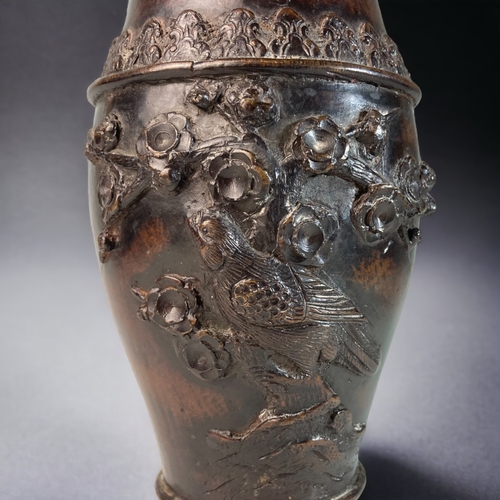 165 - A CHINESE CAST BRONZE VASE.
RELIEF DECORATED WITH BIRDS ON ROCK & CHERRY OUTCROPS. 
SIGNED TO BASE.
... 