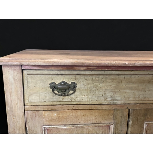 10 - A VINTAGE WAXED PINE CUPBOARD. 
WITH SINGLE DRAWER AND TWO DOORS.