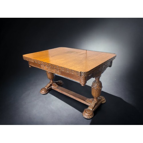 16 - A VICTORIAN CARVED OAK EXTENDING DINING TABLE.